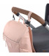 Mochila Slender Lässig rosa palo de diseño esbelto, colgada mediante ganchos negros del manillar de un carrito de bebé.