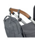 Mochila de pañales Vividal Lässig gris de tela, colgada con correas que incluye al manillar marrón de un carrito de bebé.