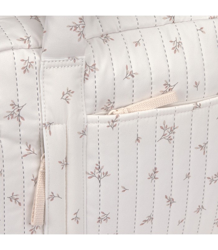 Bolso Nalea de Lässig en tela acolchada color crema con un estampado floral sutil y costuras verticales.