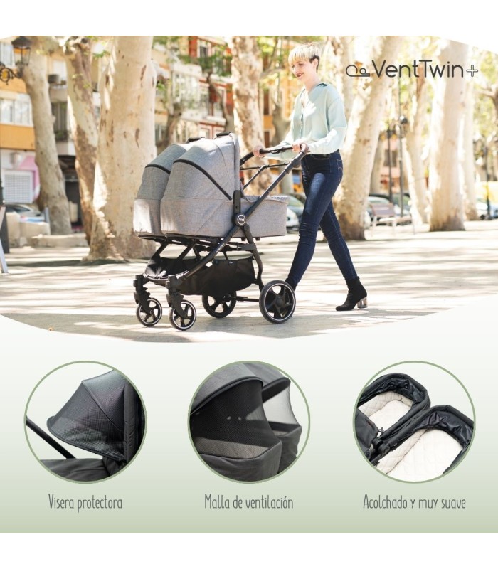 Capazo gemelar VentTwin+ Niu de tela gris con chasis negro, capotas ajustables y ventanas de ventilación de malla.